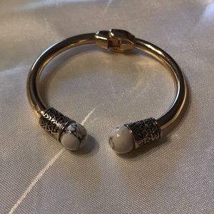 Gold bangle with marvel looking ends